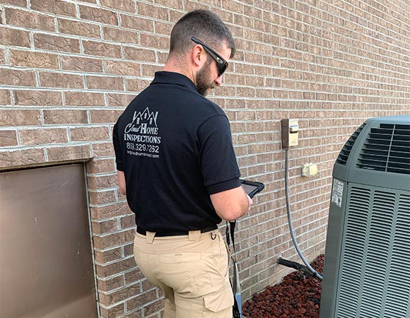 Kody Cloud, professional home inspector, inspecting an airconditioning unit.